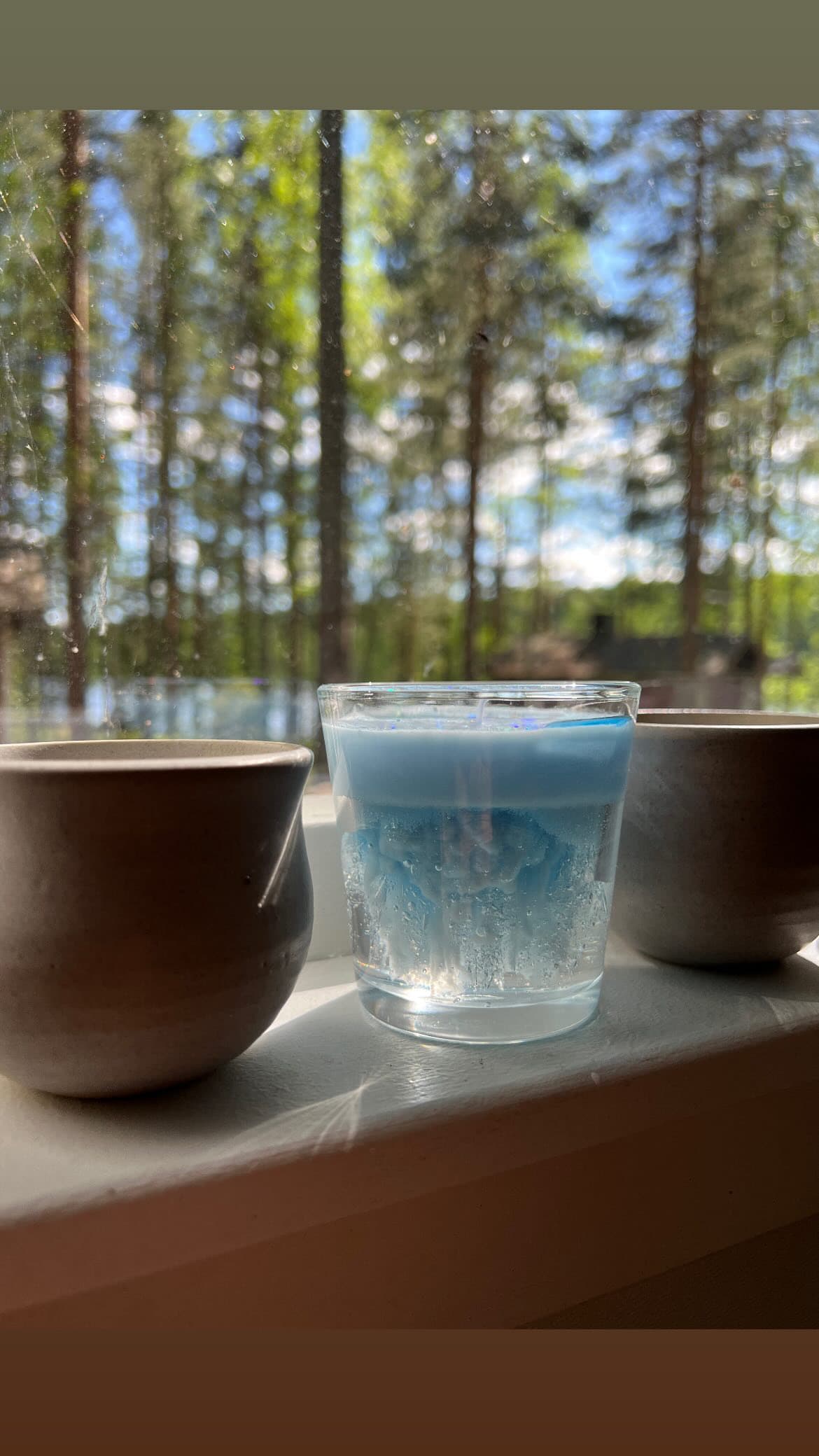 A customer’s candle on a windowsill