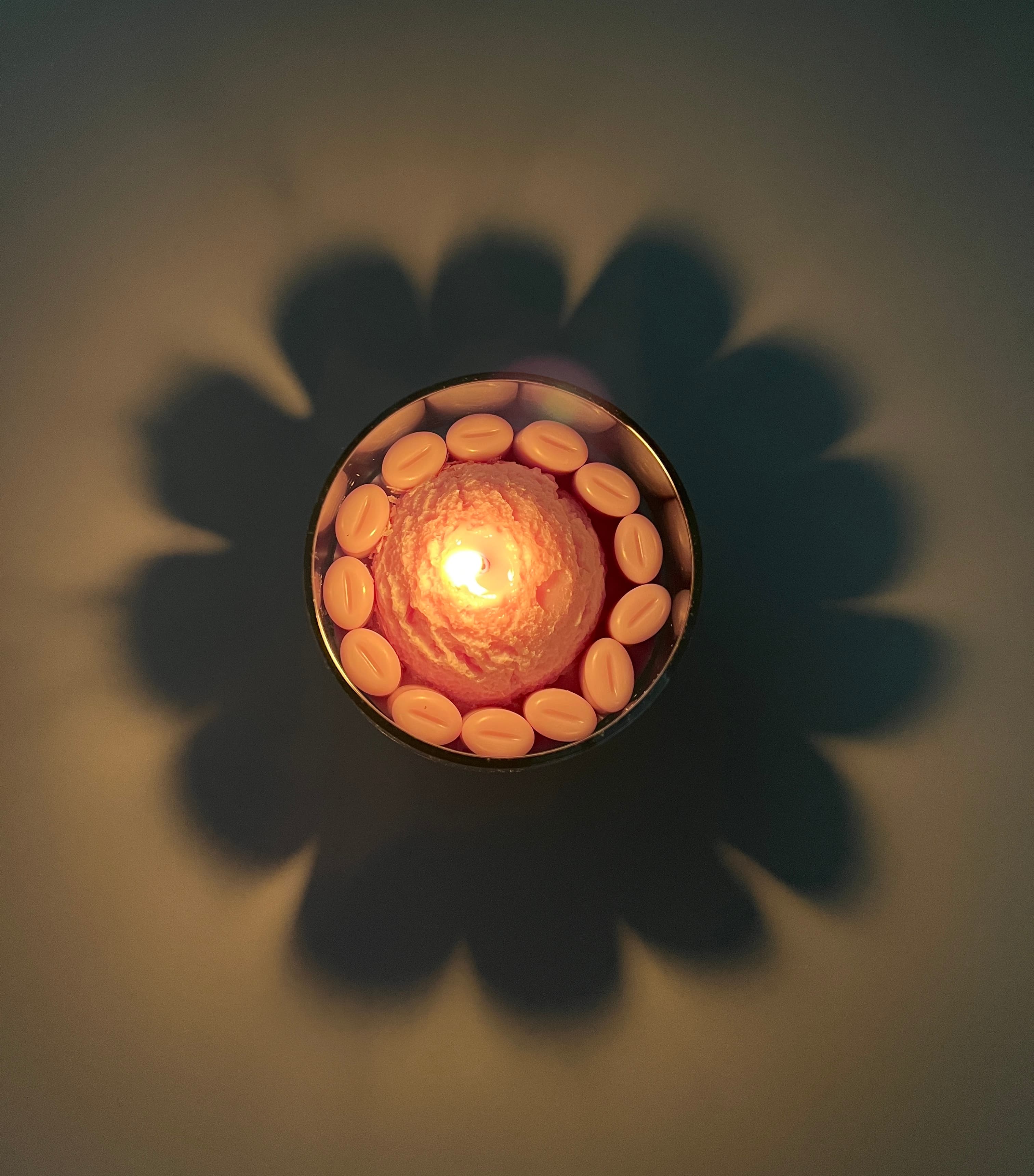 Top-down view of a customer’s lit candle