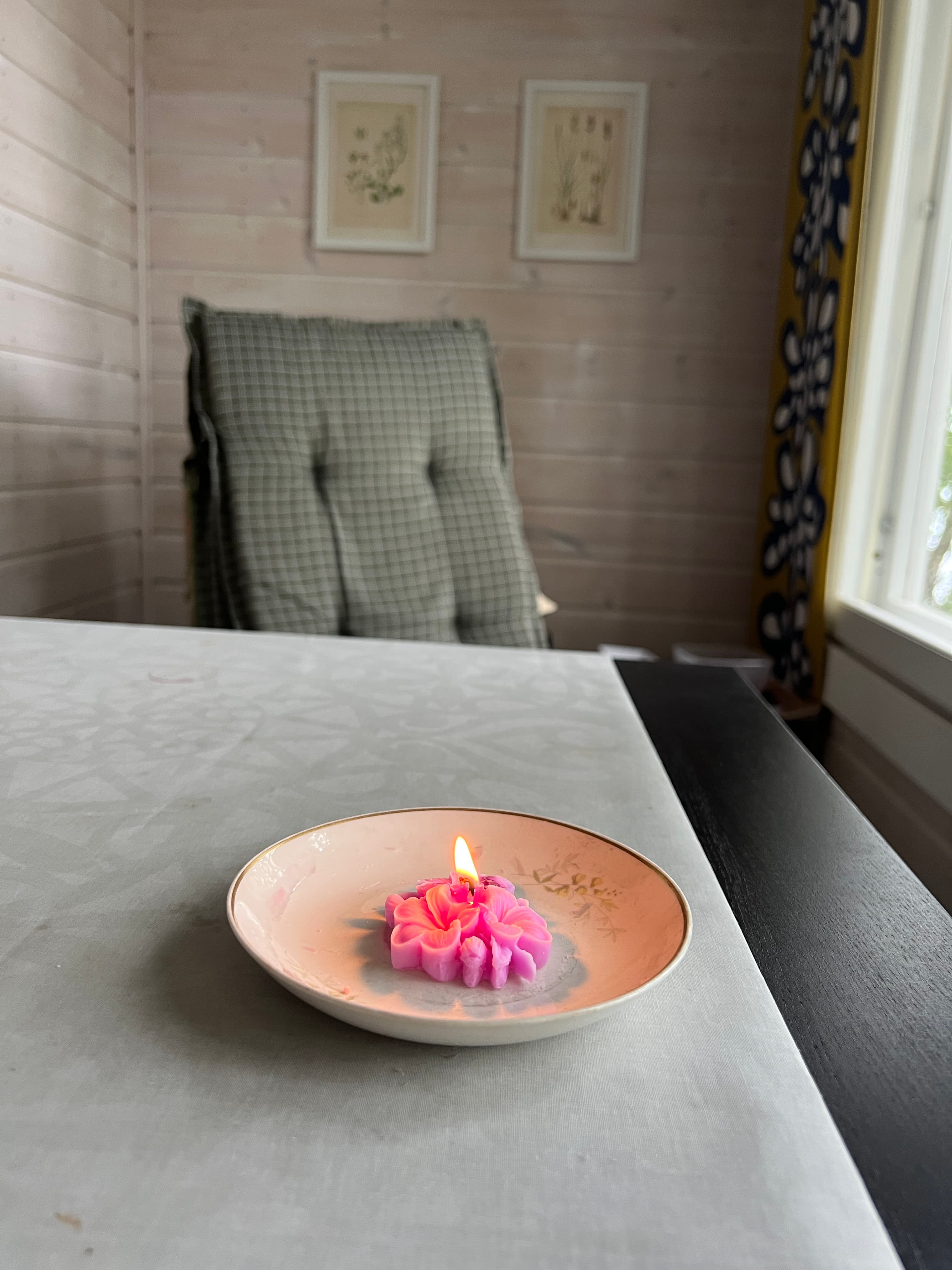 A customer’s lit flower candle